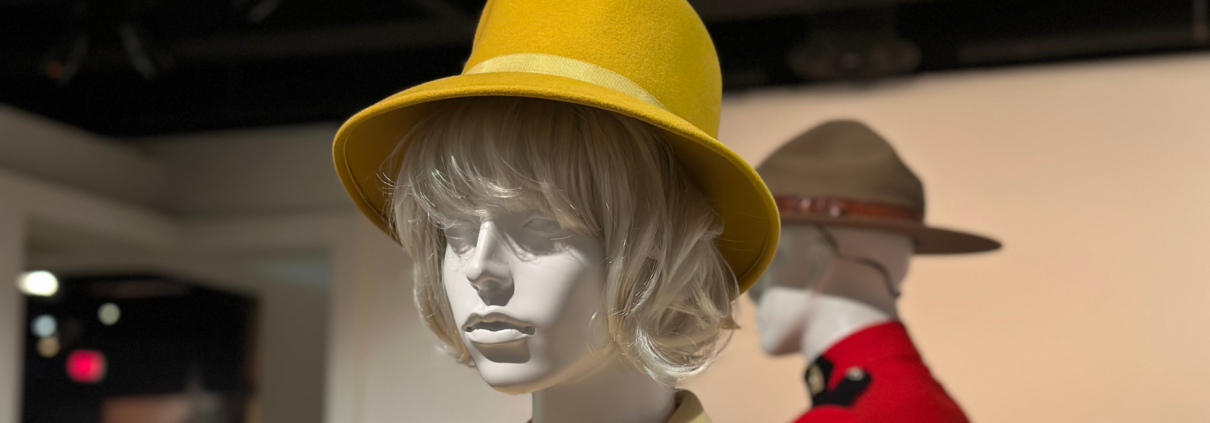 Large yellow hat on mannequin head.