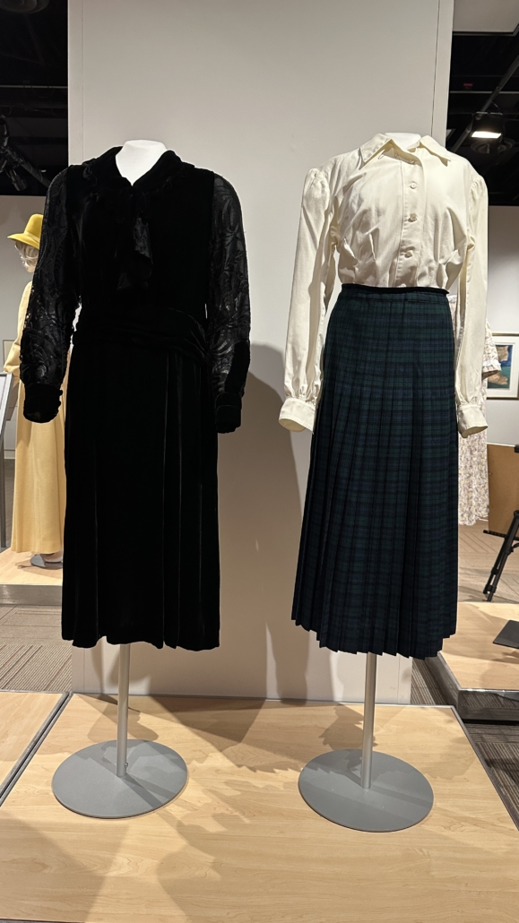 Irene Parlby's black League of Nations dress on a mannquin beside Jean Reed's Plaid Skirt on a mannequin.